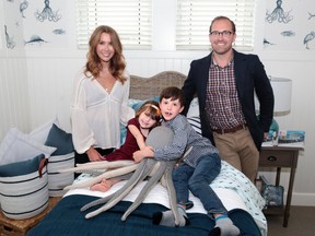 Ruby DeBoer sits with her brother Theo and parents Stacey and Mike in one of the children's bedrooms at the Kinsmen Children's Hospital Lottery show home in Harmony on Wednesday May 9, 2018. Ruby and her family were on hand to support the lottery launch. Ground-breaking surgeries performed at the Alberta Children's Hospital helped saved Ruby's life. Gavin Young/Postmedia