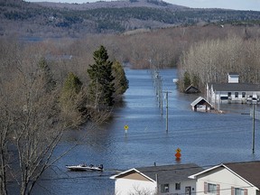 Passengers are ferried across a flooded area at Darlings Island, N.B. on Saturday, May 5, 2018.