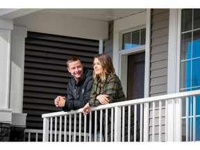 Nikki Durstling and Colton Roy enjoying the front porch of their new home in Vista Crossing.