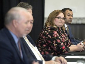 Alberta deputy premier Sarah Hoffman, listens to B.C. Premier John Horgan at the Western Premiers' Conference in Yellowknife on Wednesday, May 23, 2018.