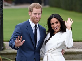 In this Nov. 27, 2017 file photo, Britain's Prince Harry and Meghan Markle pose for the media in the grounds of Kensington Palace in London, after announcing their engagement.