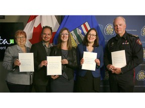(L to R) Deb Tomlinson, CEO, Association of Alberta Sexual Assault Services, MLA Brian Malkinson, Alberta Minister of Status of Women Stephanie McLean, Minister of Justice and Solicitor General Kathleen Ganley and Calgary Police Chief Roger Chaffin, hold the new best practice guide for police investigating sexual violence cases. Friday, May 25, 2018. Dean Pilling/Postmedia