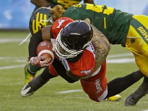 Edmonton Eskimos Levi Steinhauer (right) tackles Calgary Stampeders Tunde Adeleke during Canadian Football League game action in Edmonton on Saturday October 28, 2017. (PHOTO BY LARRY WONG/POSTMEDIA)