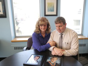 Shauna and Jason Caldwell look at photos of their 17-year-old twin sons, who died on Feb. 6, 2016 at WinSport after they crashed into a barrier between the bobsled and luge runs. Leah Hennel/Postmedia