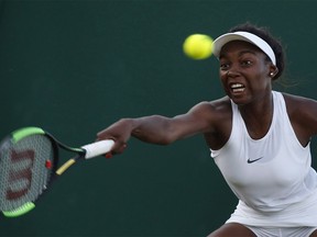 Canada's Francoise Abanda returns to Latvia's Jelena Ostapenko during their Women's Single Match on day three at the Wimbledon Tennis Championships in London Wednesday, July 5, 2017. Abanda says she doesn't get the same recognition as fellow Canadian tennis player Eugenie Bouchard because she is black. THE CANADIAN PRESS/AP/Alastair Grant ORG XMIT: CPT122