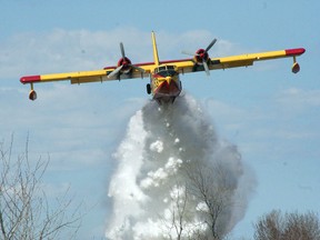 A CL-215 water bomber in action over a Manitoba wildfire.