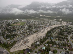 Cougar Creek rips through Canmore, Alta. during heavy flooding on Friday June 21, 2013. THE CANADIAN PRESS/Jonathan Hayward