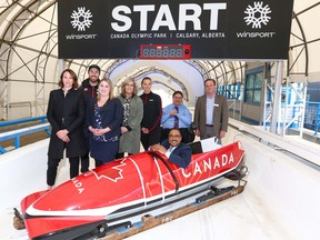 Dignitaries pose at the bobsled start area following an infrastructure  announcement in Calgary on Friday, May 11, 2018.