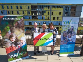 Quincy Smith, left, and Shannon Bowen-Smed, right, co-chairs of YW She Matters, stand with YWCA CEO Sue Tomney at the campaign launch on Tuesday, May 22, 2018. The goal is to complete the target of raising $60 million for the Hub facility under construction in the background.