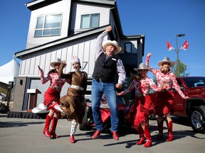 Edward Gordon, chair of lotteries committee, jumps for joy with the 2018 Calgary Stampede Royalty from left, Stampede Princess Jaden Holle, Indian Princess Cieran Starlight, Stampede Queen Lindsay Lockwood and Stampede Princess Jessica Wilson outside the 2018 Rotary Dream Home at Stampede Park in Calgary,  on Wednesday June 20, 2018. Leah Hennel/Postmedia