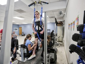 Ryan Straschnitzki on the Therastride machine at Shriners Hospital for Children in Philadelphia on Tuesday June 26, 2018.  Itís a body weight-supported manual treadmill training system that allows people with paralysis to walk. Leah Hennel/Postmedia