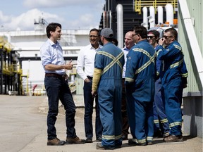 Prime Minister Justin Trudeau, Minister of Infrastructure and Communities Amarjeeet Sohi and MP Randy Boissonnault visit with workers at the Kinder Morgan Edmonton Terminal, in Edmonton Tuesday June 5, 2018.
