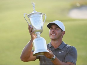 Brooks Koepka of the United States celebrates with the U.S. Open Championship trophy after winning the 2018 U.S. Open at Shinnecock Hills Golf Club on Sunday in Southampton, New York.