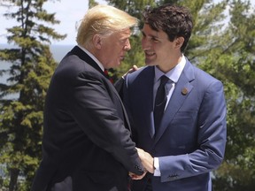 U.S. President Donald Trump is greeted by Canadian Prime Minister Justin Trudeau during the G7 Summit in La Malbaie, Quebec, Canada.