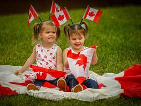 Twin sisters Olivia and Penelope Morrison  pose for a Canada Day on Friday, June 29, 2018. Al Charest/Postmedia