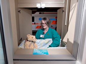 Nurse Mauri Sharun demonstrates the use of the angel cradle, during the announcement of the first newborn safe haven in Alberta at the Grey Nuns hospital, in Edmonton, Alberta on Monday May 6, 2013. The angel cradles are meant to provide an option for the safe abandonment of newborns.