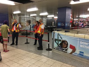 TTC Supervisors man a barricade closing off the stairway to line 2 at the Bloor/Yonge subway station in Toronto, Ont. on Monday, June 18 2018.