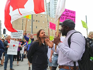 Pro and anti Trans Mountain pipeline argue after anti pipeline protester delivered a petition to Liberal MP Kent Hehr's office in downtown Calgary on Monday June 4, 2018. The petition was demanding a stop to the government's plan to buy Trans Mountain.