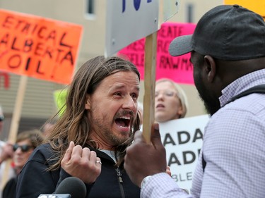 Pro and anti Trans Mountain pipeline argue after anti pipeline protester delivered a petition to Liberal MP Kent Hehr's office in downtown Calgary on Monday June 4, 2018. The petition was demanding a stop to the government's plan to buy Trans Mountain.