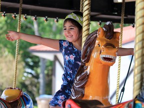 Natalie Myers has fun riding the horses on the carousel at Spruce Meadows on Wednesday June 6, 2018. The much loved Chinook Centre carousel has found a new home at Spruce Meadows. Gavin Young/Postmedia