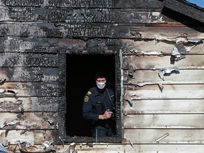 Fire investigators examine the scene of an overnight fatal fire in the 100 block of 25th avenue northeast in Calgary's Tuxedo neighbourhood on Sunday June 24, 2018. One person died in the two alarm blaze. Gavin Young/Postmedia