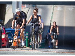 Cyclists ride out of downtown into Calgary's beltline on the 5th street bike lane on Wednesday June 27, 2018. Gavin Young/Postmedia