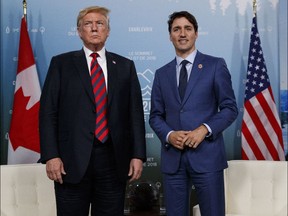 In this June 8, 2018 file photo, U.S. President Donald Trump meets with Canadian Prime Minister Justin Trudeau at the G-7 summit in Charlevoix, Canada.