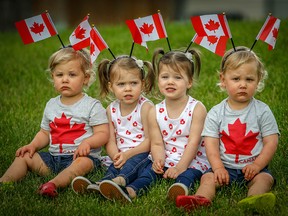 Twin brothers Cooper (left) and Eddie (right) McIndoe pose for a Canada Day photo with their neighbour's twin sisters Olivia and Penelope Morrison on Friday, June 29, 2018.