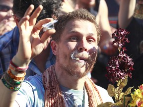 A man lights up at 4/20 celebrations in Vancouver. A city of Calgary committee voted 6-2 in favour of amending a bylaw to allow designated cannabis consumption zones at festivals and public events.