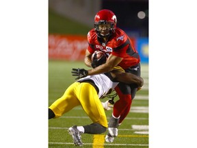 The Stamps' Lemar Durant is tackled by Ticats defender during CFL action between the Hamilton Tiger Cats and the Calgary Stampeders in Calgary at McMahon Stadium Saturday, July 29, 2017. Jim Wells/Postmedia