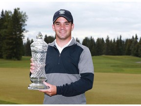 Étienne Papineau, from St-Jean-sur-Richelieu, QC raises the trophy after the winning the Glencoe Invitational golf tournament at the Glencoe Golf and Country Club in Calgary on Saturday, June 16, 2018. He won a threee round score of 1 over 217 en route to a four-shot victory. Jim Wells/Postmedia