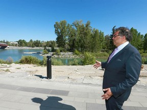 Mayor Naheed Nenshi walks near the Peace Bridge on the south side of the Bow River as reflects on how the city has changed, five years after the 2013 flood in southwest Calgary on  Wednesday, June 20, 2018. The 2013 Southern Alberta flood caused significant social and economic disruption, and unprecedented damages. Jim Wells/Postmedia