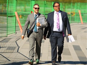 Daorcey Le Bray (L), Communication advisor to Calgary Mayor Naheed Nenshi, joins Nenshi (R) as they walk to an event to reflect how Calgary has changed five years after the 2013 flood in southwest Calgary on Wednesday, June 20, 2018. The 2013 Southern Alberta flood caused significant social and economic disruption, and unprecedented damages. Jim Wells/Postmedia