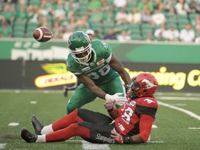 Saskatchewan Roughriders linebacker Alexandre Chevrier gets tangled up with the Calgary Stampeders defensive back Brandon Smith during first half pre-season CFL action at Mosaic Stadium in Regina on Friday, June 8, 2018. THE CANADIAN PRESS/Mark Taylor ORG XMIT: MT116