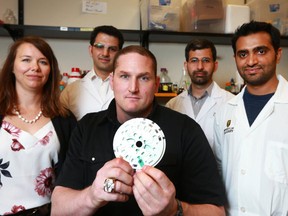 Former Calgary Stampeder Jeff Pilon joins (L-R) physician Chantel Debert and University reasearchers Mehdi Mohmmadi, Amir Nezhad, and Sultan Khadani as they pose in Calgary at the University of Calgary on Tuesday, June 26, 2018. Researchers at the University of Calgary have taken an important step towards fast and accurate diagnosis of head trauma-related brain injuries, including concussion. Currently difficult to detect due to a limited availability of reliable tools for rapid and continuous monitoring, brain injuries may soon be diagnosed quickly and accurately with the aid of a simple blood test.Jim Wells/Postmedia