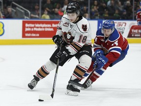 Edmonton's Davis Murray (right) reaches for Calgary's Riley Stotts during the first period of a WHL game between the Edmonton Oil Kings and the Calgary Hitmen at Rogers Place in Edmonton, Alberta on Saturday, March 17, 2018. Photo by Ian Kucerak/Postmedia Photos for Derek Van Diest story running in Sunday, March 18 edition.