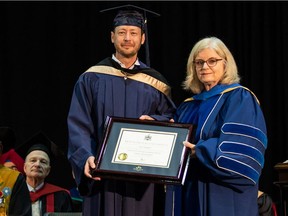 Paul Brandt receives his honorary degree from Susan Mallon, chair of the Mount Royal University board of governors.