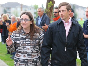 Edouard Maurice and his wife Jessica walk into Okotoks court on May 17, 2018.