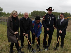 Minister of Infrastructure Sandra Jansen, left, City Councillor Ward Sutherland, Hal Eagle Tail of Tsuut'ina Nation, Calgary police Chief Roger Chaffin and Calgary police commission chair Brian Thiessen break the ground at the site of the Spyhill Services Centre.