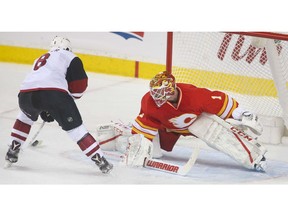 Flames goalie Brian Elliott slides over to stop Coyotes Tobias Rieder on a break away during NHL action between the Arizona Coyotes and the Calgary Flames at the Scotiabank Saddledome in Calgary, Alta. on Saturday December 31, 2016. Jim Wells/Postmedia