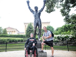 Ryan Straschnitzki and his dad Tom pose for photos at the Rocky statue at the Philadelphia Museum of Art on Wednesday June 27, 2018.
