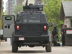 Calgary police outside an apartment building in the 1600 block of 12th Avenue S.W., where a group of people have been barricaded in an apartment building since early Friday morning, June 22, 2018.