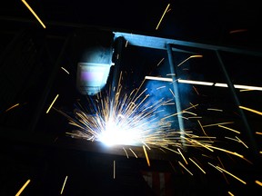 A welder fabricates a steel structure at an iron works facility in Ottawa on March 5, 2018. Following the G7 meetings in Quebec on Saturday, Trudeau said newly imposed U.S. tariffs  on steel and aluminum  were insulting.
