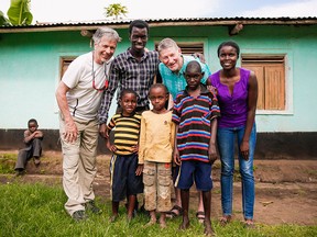 Bernie Potvin (far left) and Ross Weaver (light blue shirt) pose with therapists Charles Remo Joseph and Rehema Mutoni outside the home of their young clients. The therapists work for Kyaninga Child Development Centre in western Uganda, which provides free therapy for kids with disabilities.