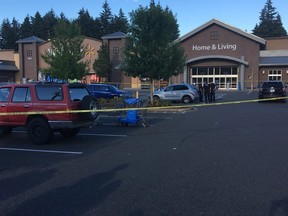 Police officers investigate the scene of a deadly shooting at a Walmart store in Tumwater, Wash., Sunday, June 17, 2018.