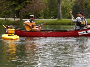 University of Calgary Outdoor Centre instructors, Aaron Fleming and Steven Wapple take a break and enjoy the weather before teaching a boat class at Bowness Park in Calgary on Tuesday June 5, 2018. Darren Makowichuk/Postmedia