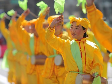Members of Falun Dafa perform during the 2018 Calgary Stampede Parade in Calgary, on Friday July 6, 2018. Leah Hennel/Postmedia