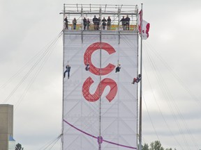 From left to right champion chuckwagon driver Chad Harden Chad Harden, 2018 Canadian Olympic skeleton racer Elisabeth Vathje, Stampede sidesaddle racer Hailey Stewart Hailey Stewart and 2018 Canadian Olympic bobsledding Gold Medalist and three-time Olympian Justin Kripps fly down the 2018 Calgary Stampede Zipline on Wednesday, July 4, 2018. (Zach Laing / Postmedia Network)