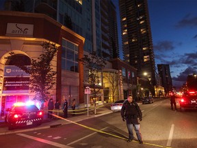 Calgary police direct traffic after severe winds tore out windows in an apartment building at 11 ave and 3st s.e. in Calgary, Ab., on Friday July 13, 2018. Mike Drew/Postmedia