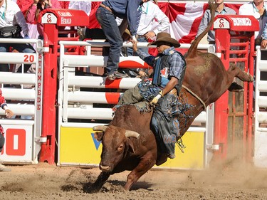 Marcos Gloria, Edmonton, rides Rattler for the win in the Bull Riding final in the Stampede Rodeo at the Calgary Stampede in Calgary, Ab., on Sunday July 15, 2018. Mike Drew/Postmedia